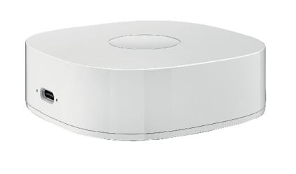 Vit, fyrkantig enhet med rundade kanter och en USB-port på sidan.